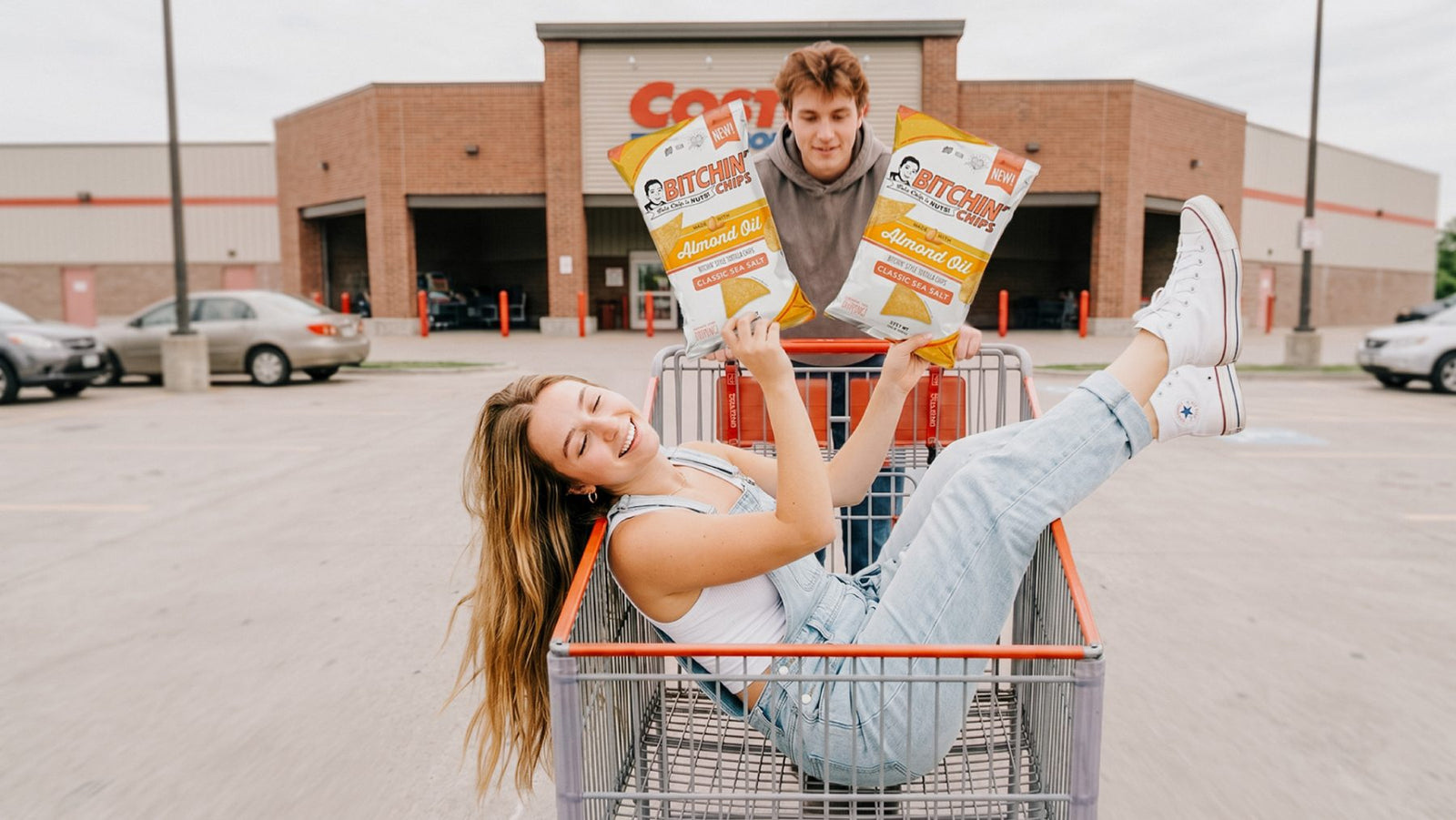 Shoppers with bags of Bitchin' Chips in a cart outside a Costco warehouse