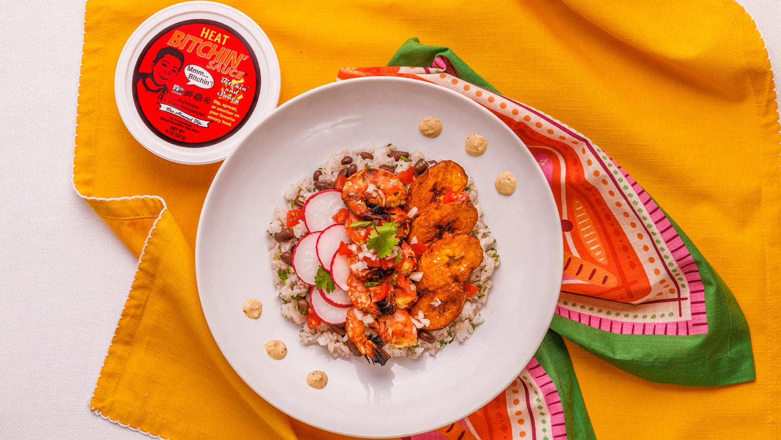 Heat Bitchin' Sauce vegan hot sauce with a shrimp, rice, and plantain bowl