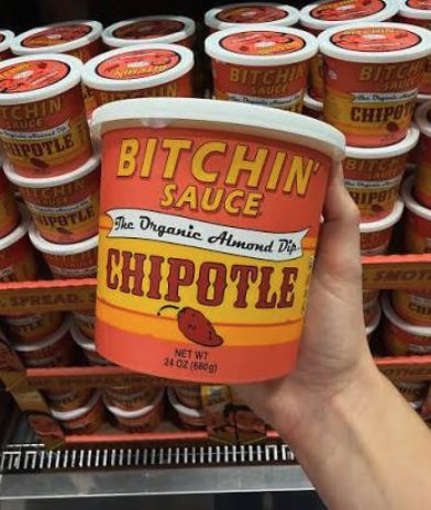Hand holding a 24-ounce tub of Organic Chipotle Bitchin' Sauce at Costco