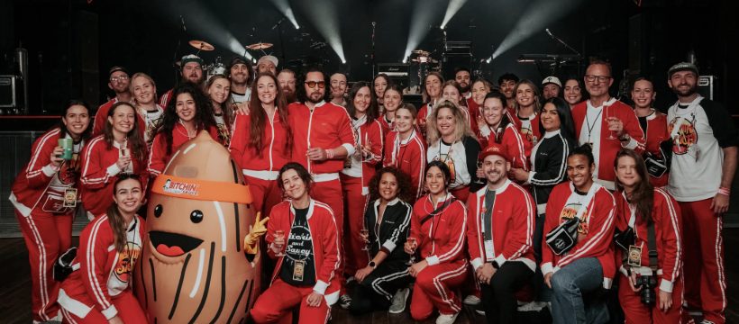 The Bitchin' Sauce team in red jumpsuits with the life-sized almond mascot