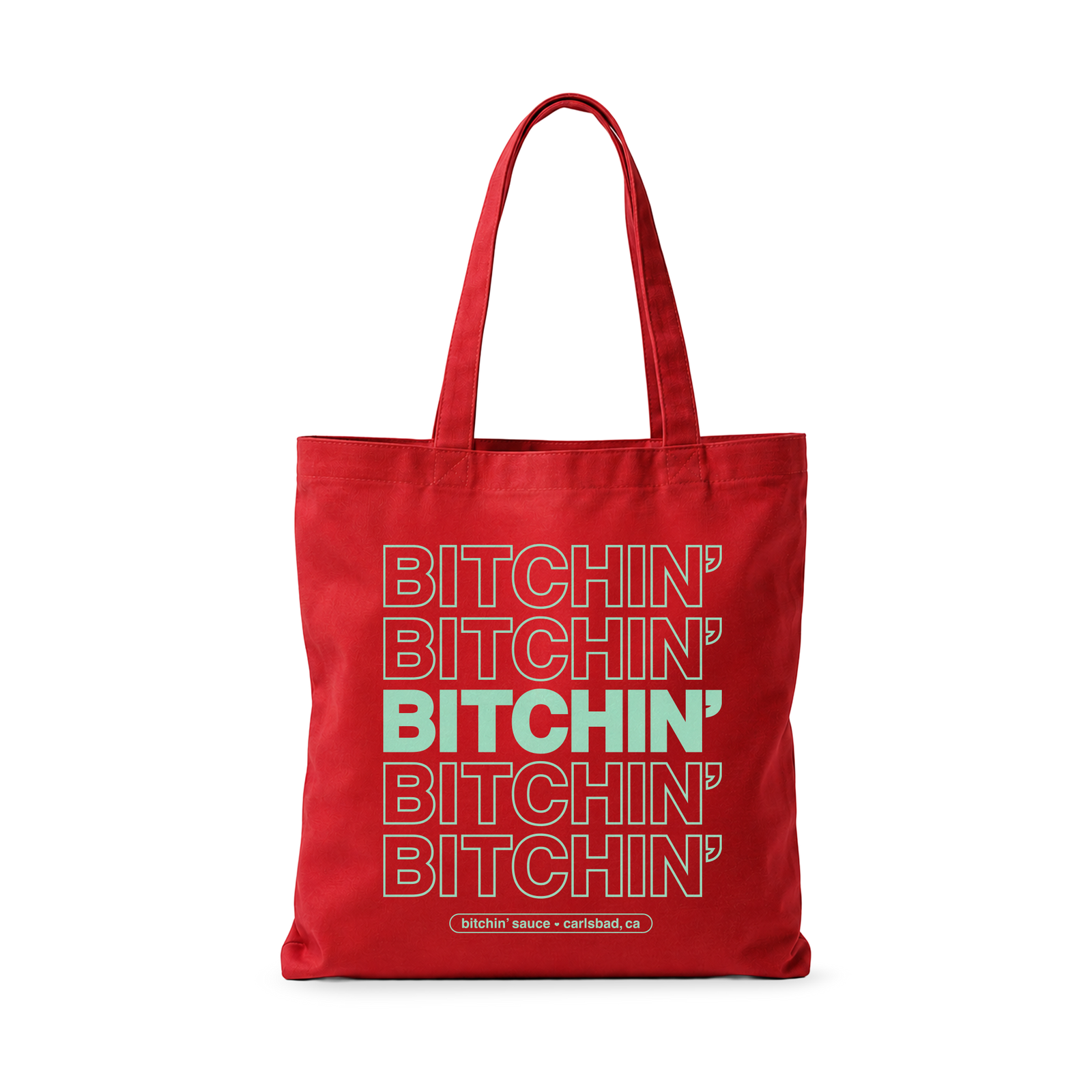A red canvas tote bag with long handles, featuring a stacked graphic print of the word 'BITCHIN'' in white outlined letters, with the middle word printed in solid mint green. A small brand label at the bottom reads 'BITCHIN' SHOE • COMBAT CHIC'.