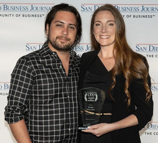 Starr Edwards and L.A. Edwards holding the San Diego Business Journal CEO of the Year award